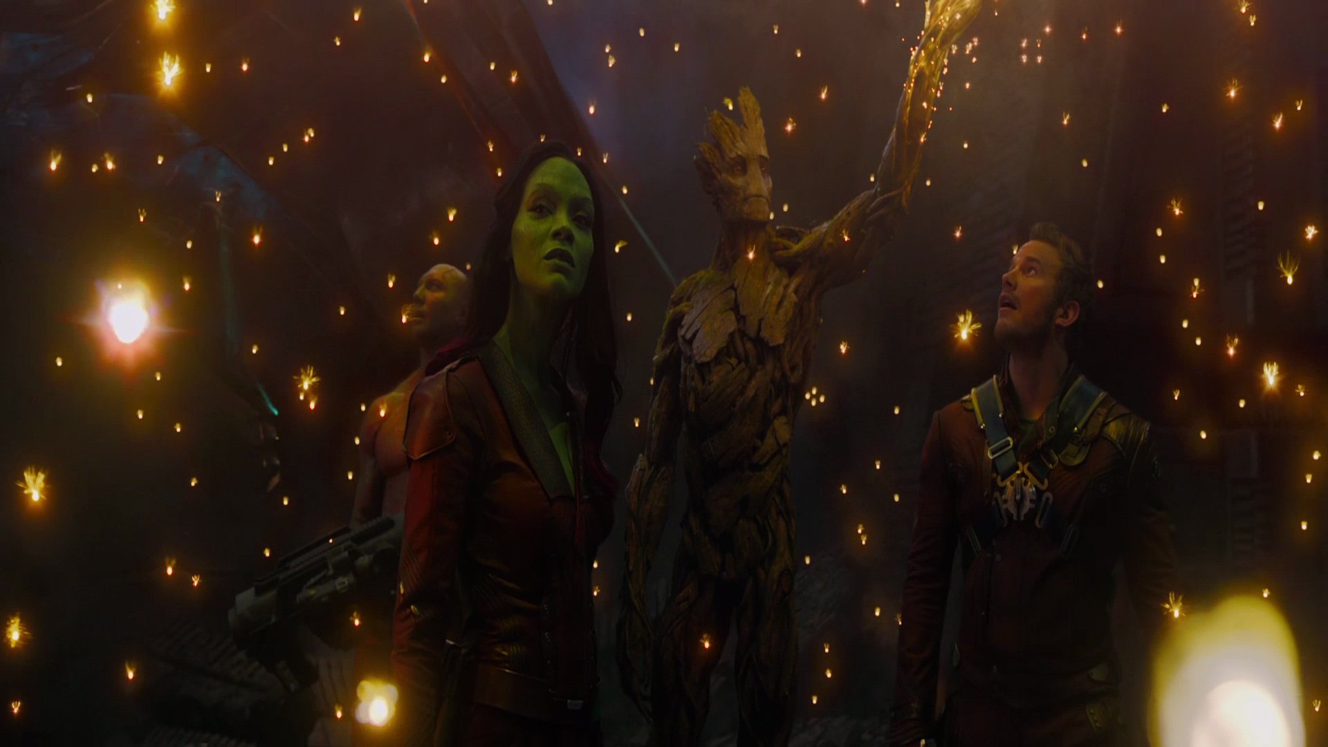 A vibrant scene from *Guardians of the Galaxy*, featuring Drax, Gamora, Peter Quill, and Groot against a backdrop of glowing lights, showcasing the film's adventurous spirit.