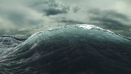 HD PC desktop wallpaper featuring a powerful ocean wave under a moody, overcast sky, capturing the raw beauty of nature.