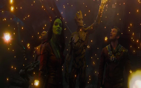 A vibrant scene from *Guardians of the Galaxy*, featuring Drax, Gamora, Peter Quill, and Groot against a backdrop of glowing lights, showcasing the film's adventurous spirit.