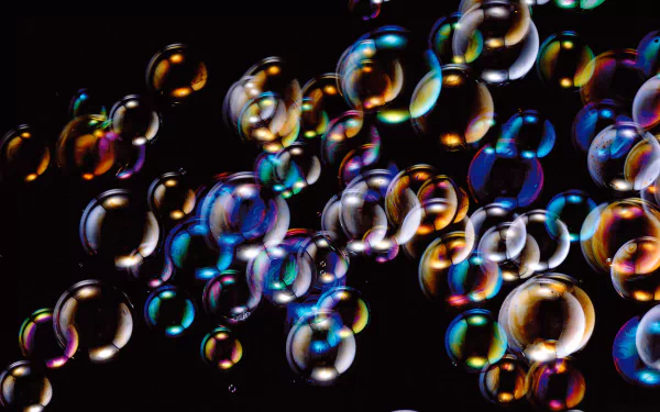 A vibrant collection of shimmering bubbles against a black background, showcasing a spectrum of colors, suitable as an HD desktop wallpaper or background.