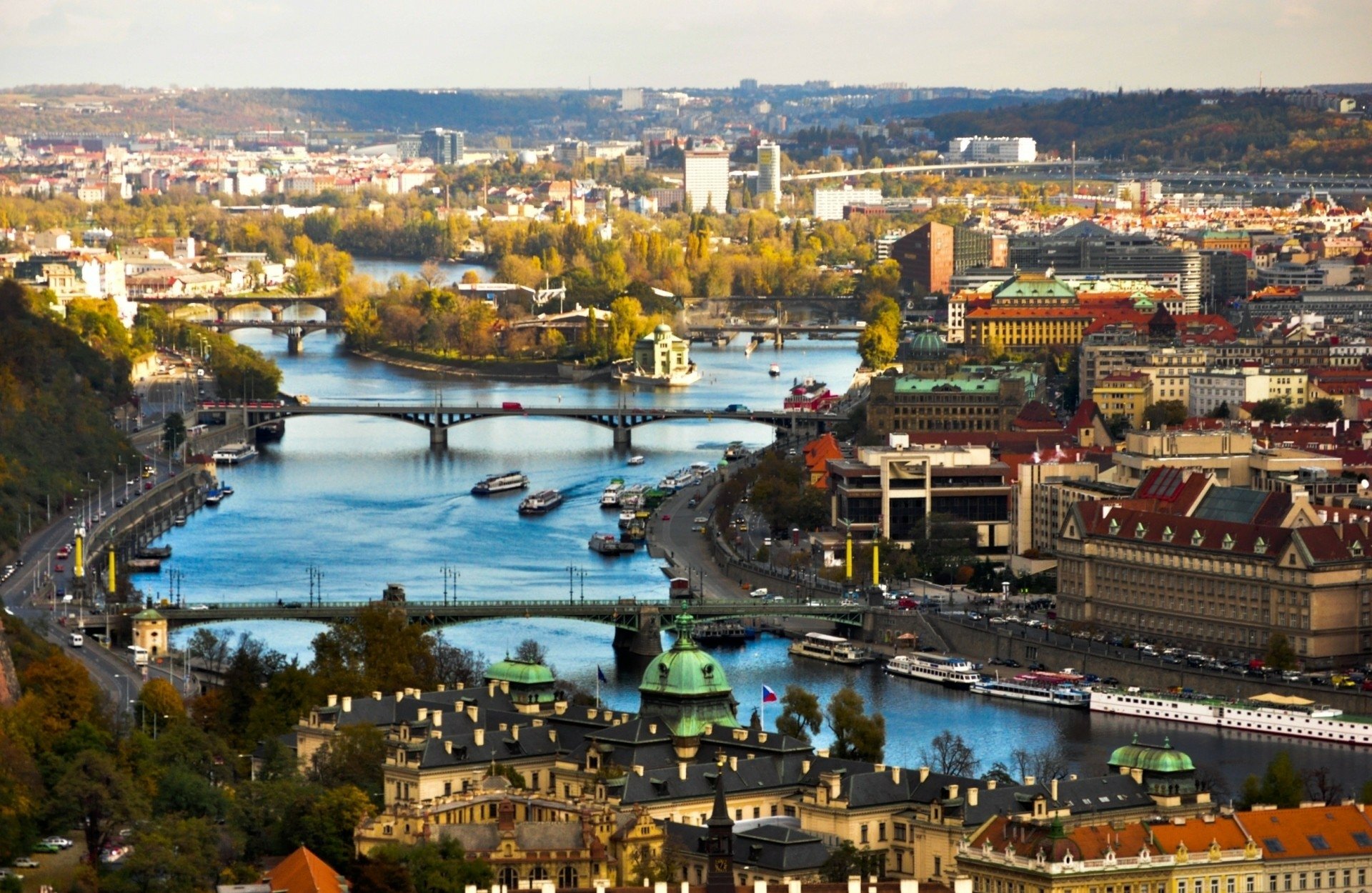 HD PC desktop background: panoramic man-made cityscape of Prague, Czech Republic, featuring the Vltava River, multiple bridges and historic riverside buildings.
