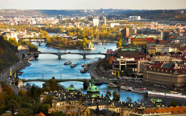 HD PC desktop background: panoramic man-made cityscape of Prague, Czech Republic, featuring the Vltava River, multiple bridges and historic riverside buildings.