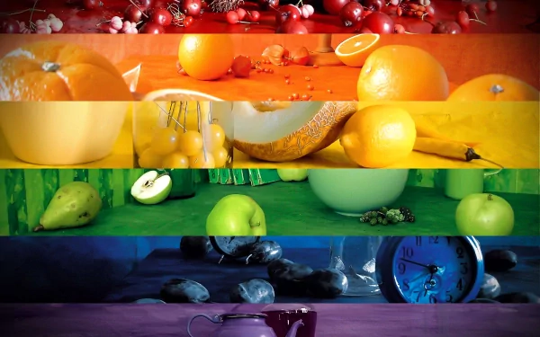 A vibrant HD desktop wallpaper featuring a colorful arrangement of various fruits, showcasing red, orange, yellow, green, and blue tones for a fresh and lively background.