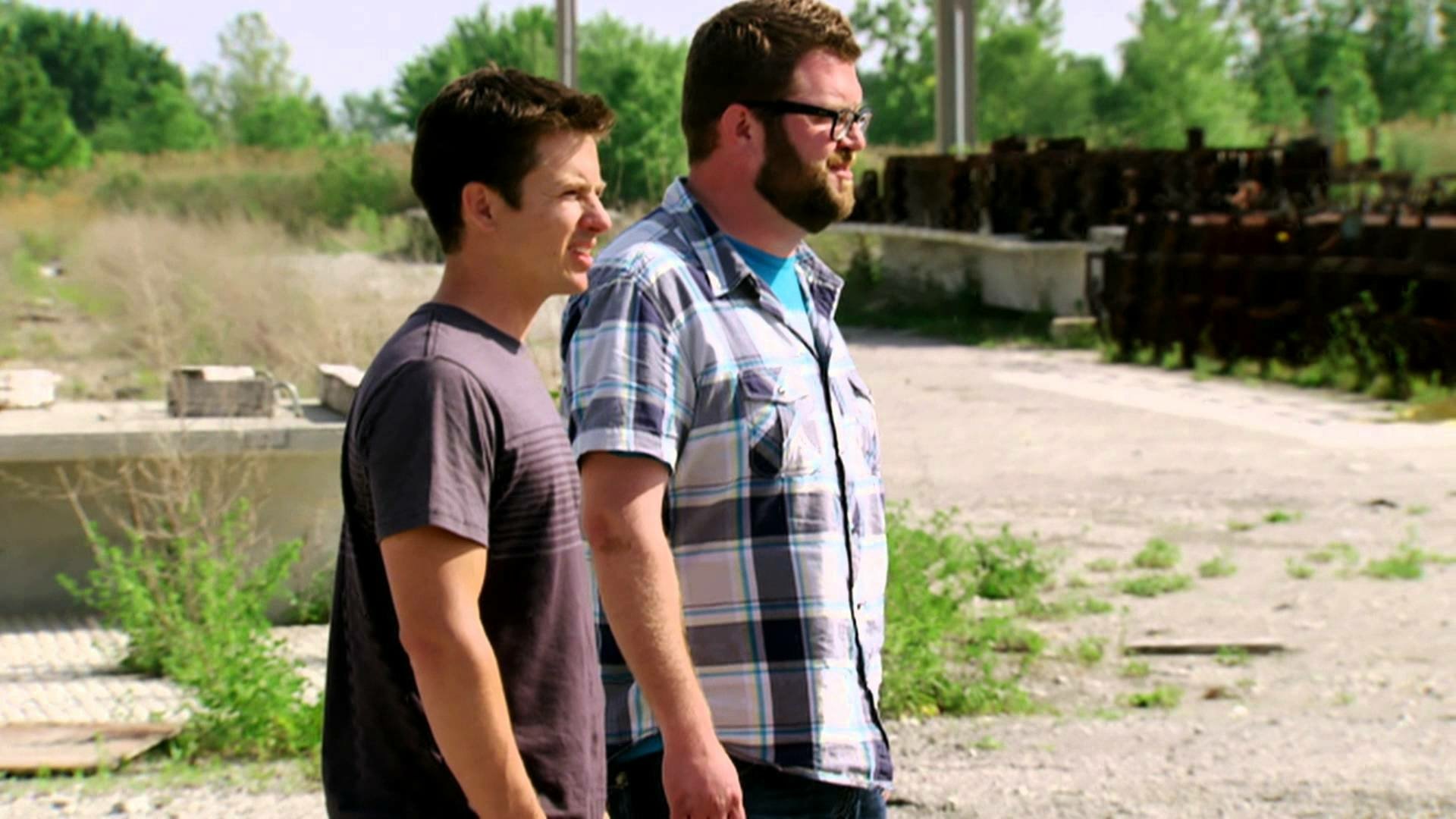 HD desktop wallpaper from Top Gear featuring two presenters standing outdoors with a gritty backdrop.