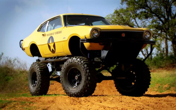 HD Top Gear-themed desktop wallpaper featuring a yellow monster truck on a dirt track.