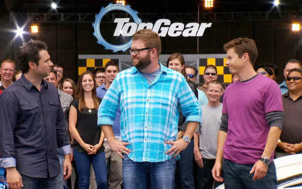 HD desktop wallpaper featuring the cast of Top Gear with the show's logo in the background, surrounded by an audience.