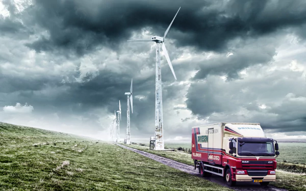 A DAF vehicle drives on a road beside wind turbines under dramatic cloud-filled skies in the Netherlands, captured in 4K Ultra HD.