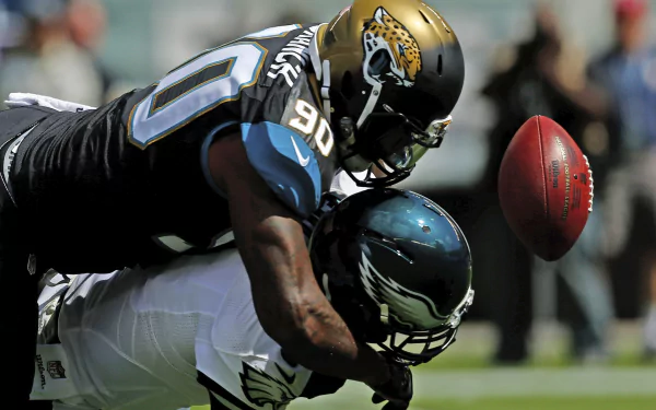 HD desktop wallpaper featuring a dynamic football action scene with Philadelphia Eagles and Jacksonville Jaguars players in intense mid-game moment.