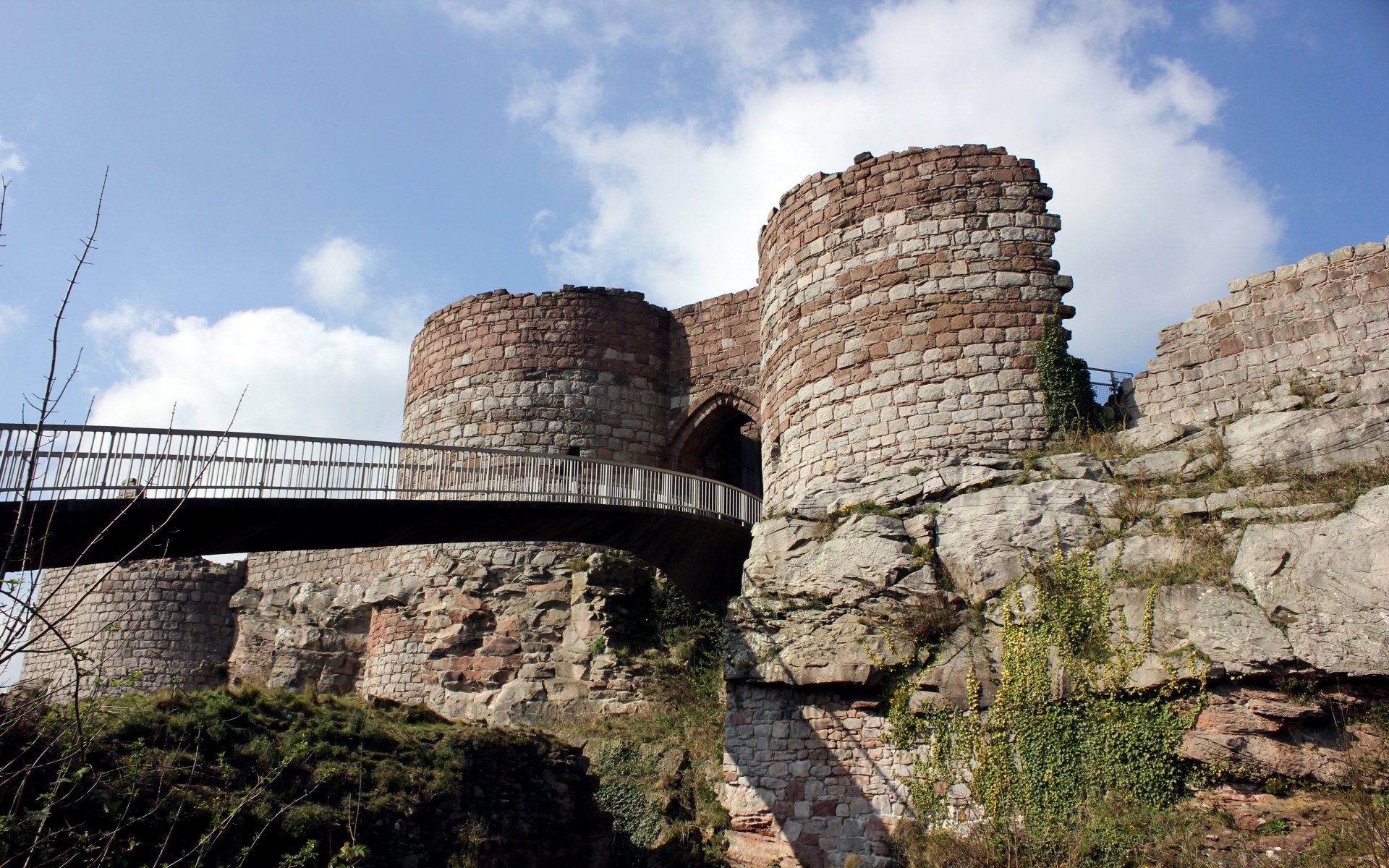 HD PC desktop wallpaper/background: man-made Beeston Castle stone towers and footbridge on a rocky outcrop beneath a blue sky with scattered clouds.