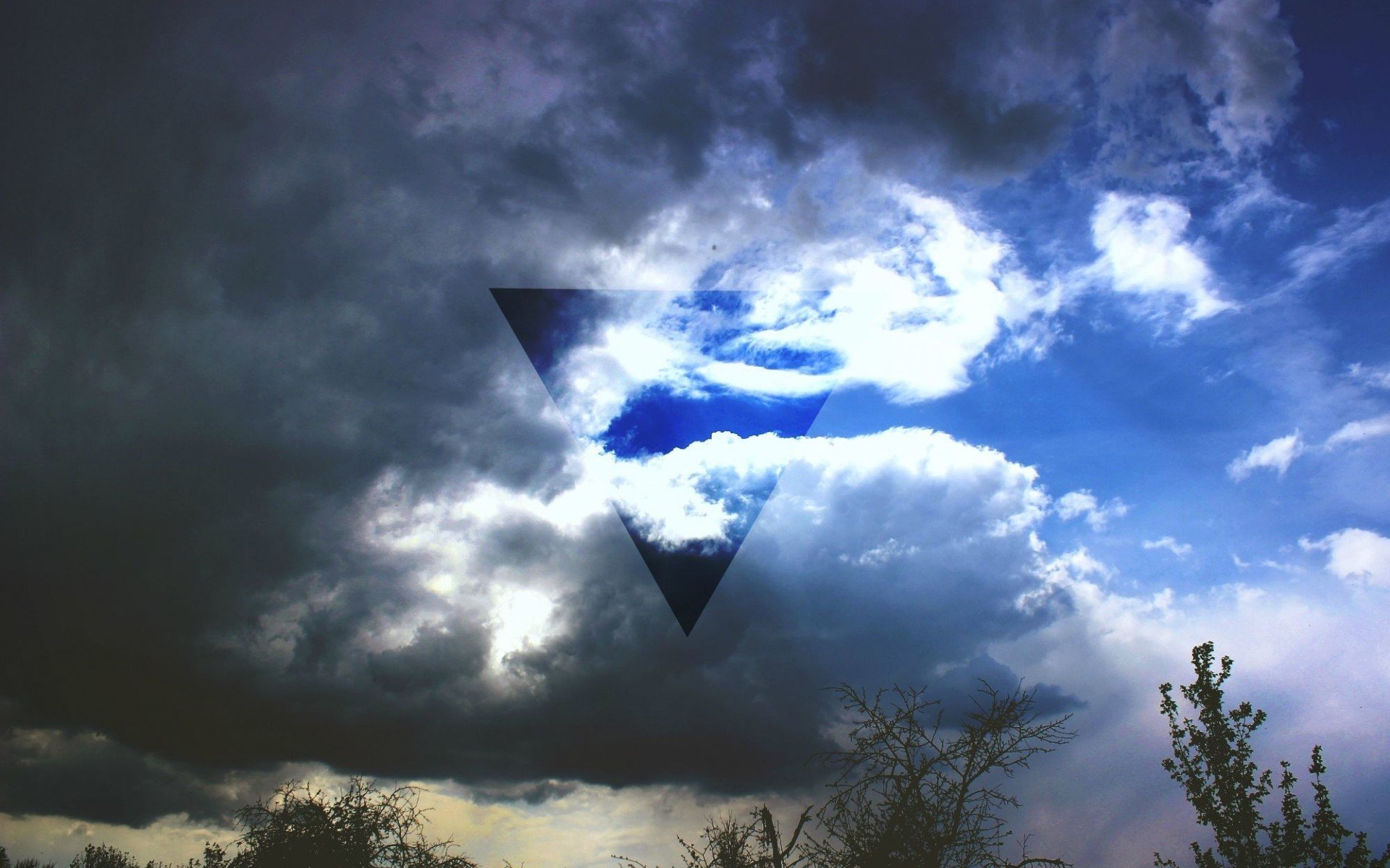 HD sci-fi desktop wallpaper featuring a dark sky with dramatic clouds and a transparent black triangle overlay at the center, blending with the moody atmosphere.