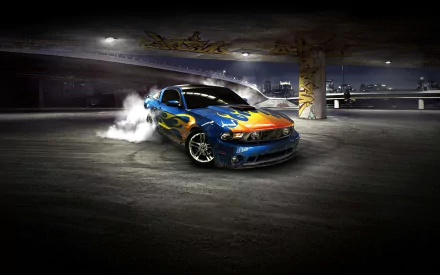 Blue Ford Mustang Shelby with flame livery drifting in a dim parking garage, tires smoking — HD PC desktop wallpaper background.