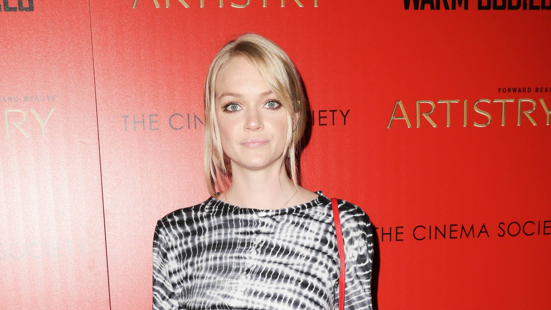 HD desktop wallpaper featuring American model Lindsay Ellingson posing against a red backdrop with event branding.