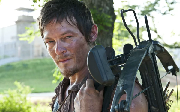 HD desktop wallpaper featuring Norman Reedus as Daryl Dixon from the TV show The Walking Dead, with Daryl carrying a crossbow and standing outdoors.