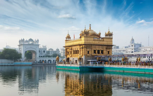 A stunning HD wallpaper featuring the iconic Golden Temple (Harmandir Sahib) set against a serene reflection in the water, showcasing its religious significance and architectural beauty.