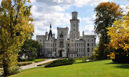 Hluboká Castle near České Budějovice in Bohemia, Czech Republic — a white neo‑Gothic chateau framed by autumn trees and lawns; HD PC desktop wallpaper of a man-made landmark.