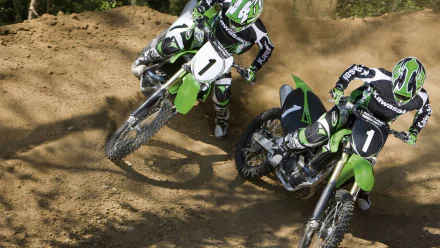 Two motocross riders compete on dirt trails, showcasing the thrill of sports in an HD desktop wallpaper background. Vivid details capture the intensity of the race.