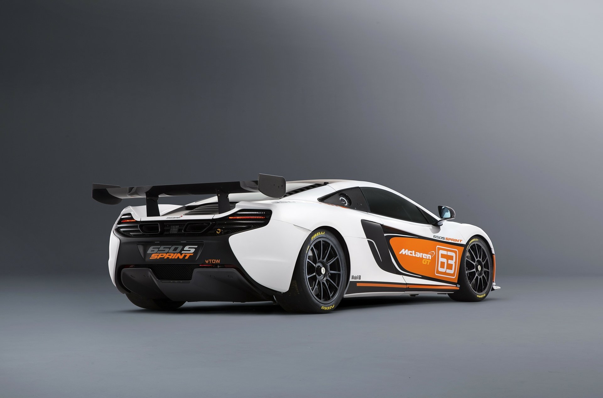 White McLaren 650S Sprint supercar rear three-quarter view with racing decals on a neutral studio background — 4K Ultra HD PC desktop wallpaper.