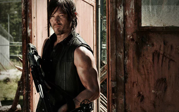 Daryl Dixon, portrayed by Norman Reedus, stands confidently with a crossbow in this HD wallpaper from The Walking Dead, set against a weathered backdrop.