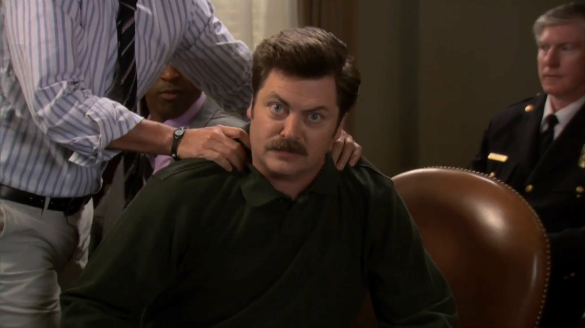 HD wallpaper of Ron Swanson from Parks and Recreation sitting in a chair with a skeptical expression.