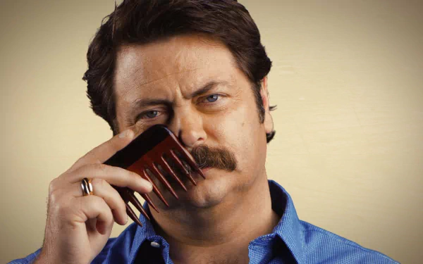 HD desktop wallpaper featuring a man with a mustache combing his mustache, evoking a strong, confident vibe.