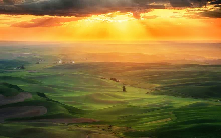 Sunset over rolling green hills in Tuscany, Italy, captured in vibrant photography for an HD PC desktop wallpaper background.