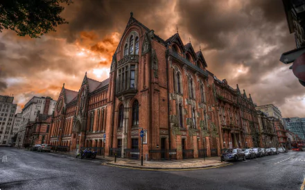 HDR image of a historic red-brick cathedral in Birmingham, England, showcasing detailed architecture under a dramatic cloudy sky.
