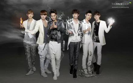 A high-definition desktop wallpaper featuring the music group EXO, showcasing six members in stylish outfits against a dramatic, smoky background.