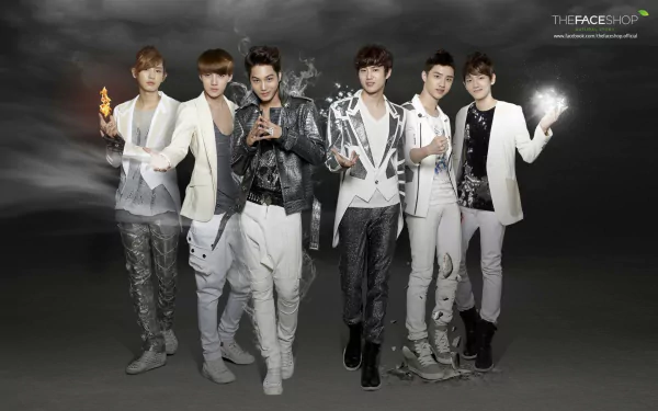 A high-definition desktop wallpaper featuring the music group EXO, showcasing six members in stylish outfits against a dramatic, smoky background.