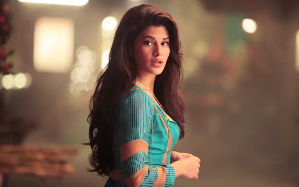 A stunning HD wallpaper featuring Bollywood celebrity Jacqueline Fernandez, showcasing her striking beauty and captivating presence in a vibrant outfit against a softly blurred background.