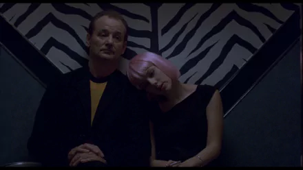 HD PC desktop wallpaper from the movie Lost in Translation: two characters sit against a zebra-striped wall, a pink-haired woman leaning on a man's shoulder in dim, moody lighting.