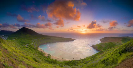 Sunset over Hanauma Bay in Hawaii, showcasing the tranquil sea, lush greenery, and vibrant sky in this HD desktop wallpaper and background.