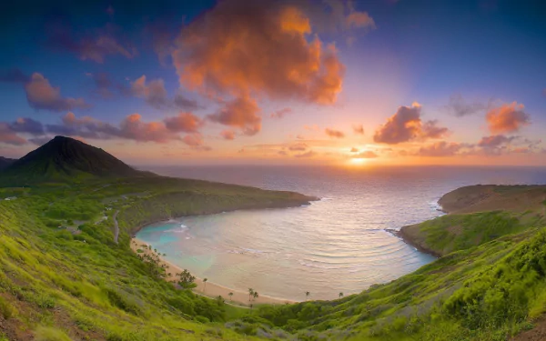 Sunset over Hanauma Bay in Hawaii, showcasing the tranquil sea, lush greenery, and vibrant sky in this HD desktop wallpaper and background.