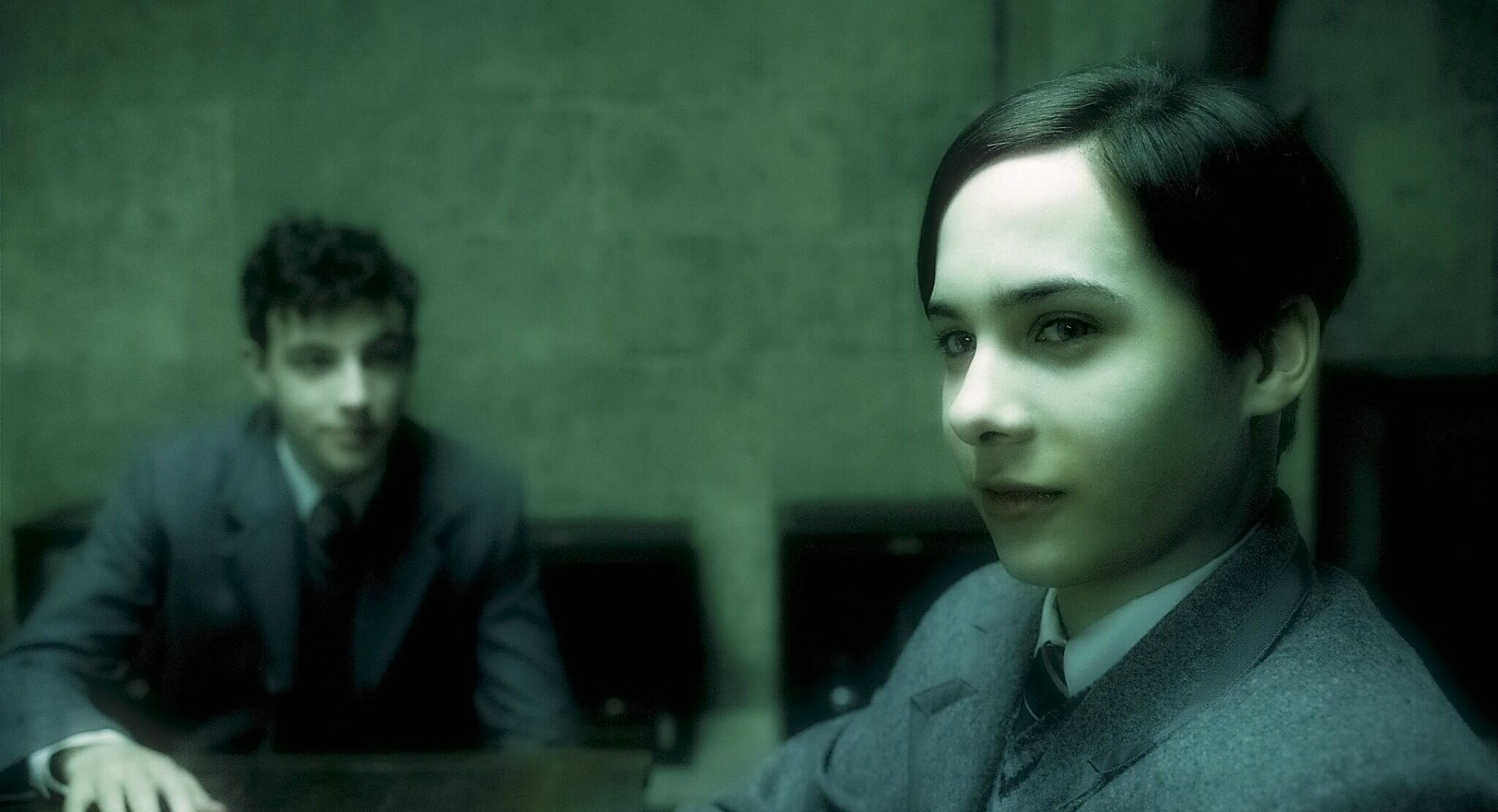 HD PC desktop wallpaper featuring a scene from the movie Harry Potter and the Half-Blood Prince, showing two characters in a dimly lit room.