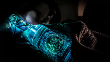 HD desktop wallpaper featuring a glowing Nuka Cola Quantum bottle from the video game Fallout, creating a captivating and atmospheric background.