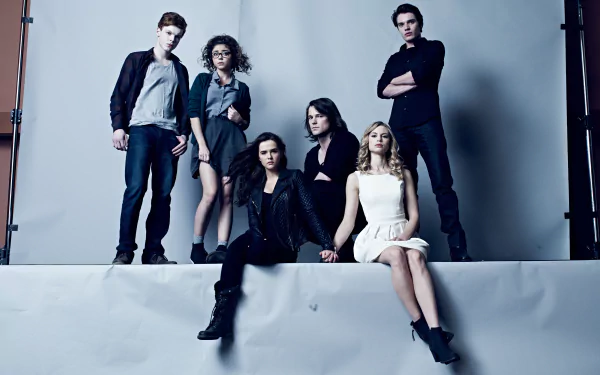 Vampire Academy movie promotional shot: six young adults pose on a gray studio backdrop with moody lighting — 5K Ultra HD PC desktop wallpaper and background.
