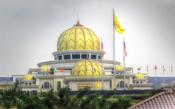 HD PC desktop wallpaper of Istana Negara, Jakarta: a man-made golden-domed presidential palace with flags and lush greenery.