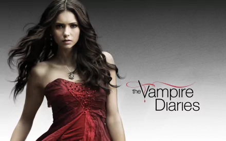 A striking HD desktop wallpaper from The Vampire Diaries, featuring a character in a captivating red dress against a sleek gray background.