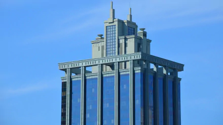 High-definition image of the State Law Building skyscraper in Brisbane, Queensland, Australia, showcasing modern architecture against a clear blue sky.