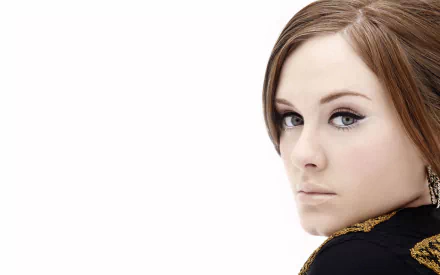 Adele, the acclaimed British singer, gazes over her shoulder in this striking HD wallpaper, highlighting her captivating presence in the music world.