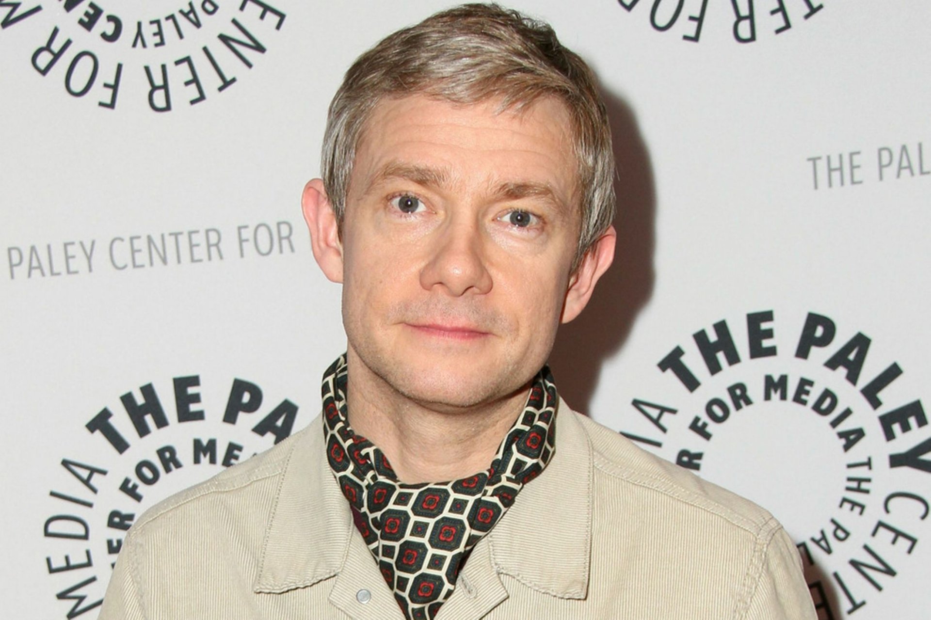 HD desktop wallpaper featuring a portrait of a man against a backdrop with Paley Center logos.