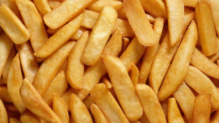 HD PC desktop wallpaper featuring a close-up view of golden, crispy French fries filling the frame.