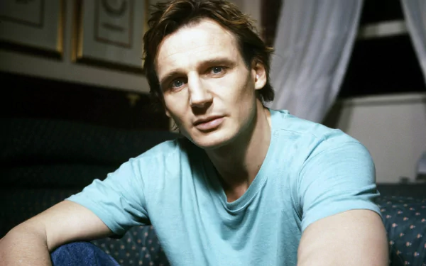 HD desktop wallpaper featuring a portrait of a man in a teal shirt, intended as a background image.