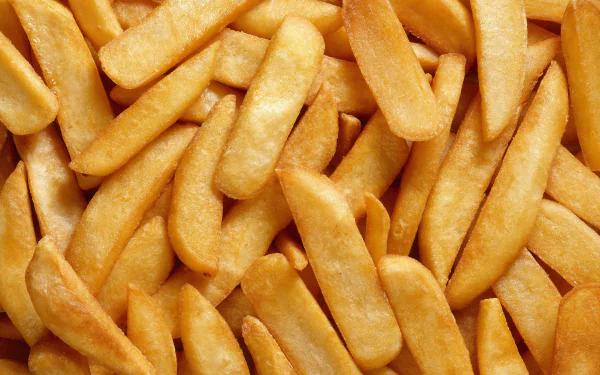 HD PC desktop wallpaper featuring a close-up view of golden, crispy French fries filling the frame.