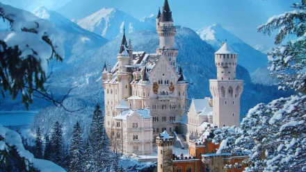 A stunning winter scene of Neuschwanstein Castle in Bavaria, Germany, surrounded by snow-covered mountains and trees, creating a magical, picturesque backdrop.