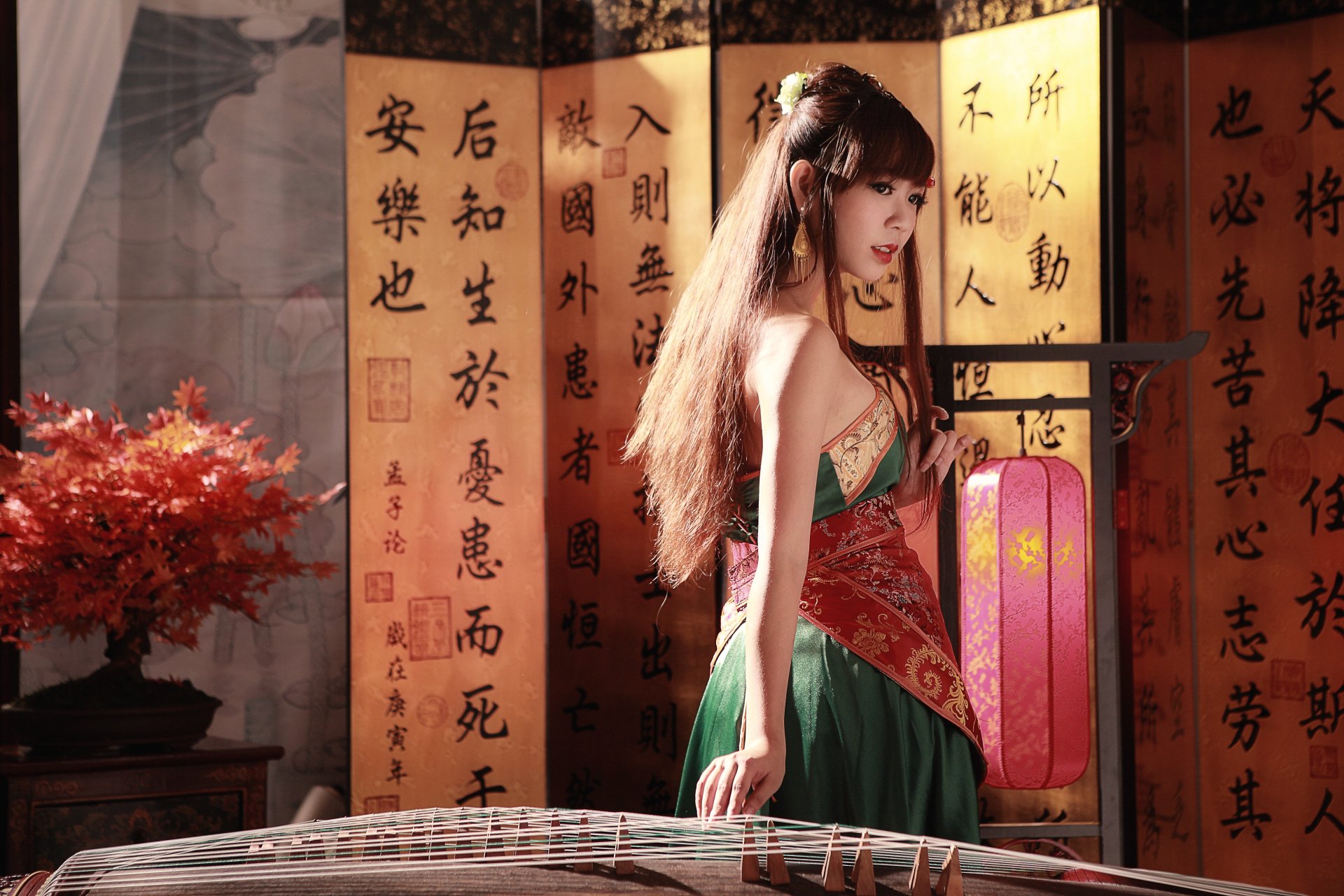 A woman in traditional Taiwanese dress stands beside a Chinese instrument, framed by calligraphed scrolls and a bonsai, embodying cultural elegance.