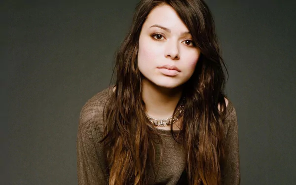 HD PC desktop wallpaper featuring celebrity Miranda Cosgrove with long brown hair against a dark, neutral background.