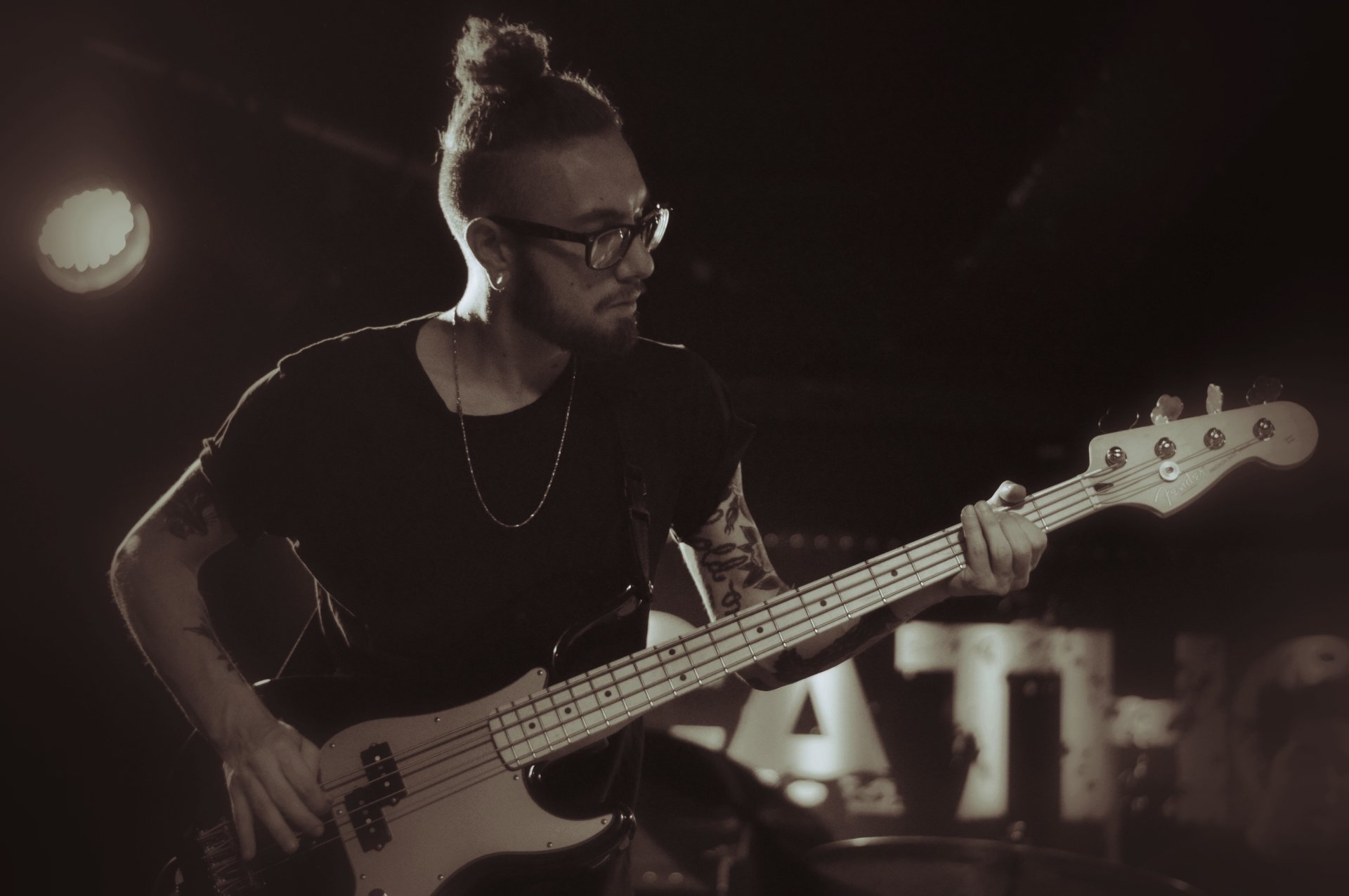 HD desktop wallpaper of Being As An Ocean's bass player performing live on stage, immersed in the music.