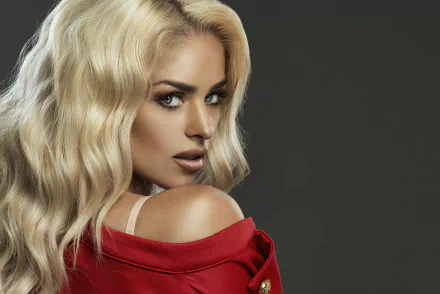 4K Ultra HD desktop wallpaper featuring a confident woman model with long blonde hair, wearing a red garment, against a dark background.