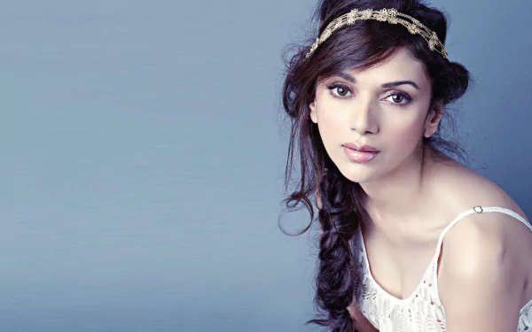 HD desktop wallpaper featuring celebrity Aditi Rao Hydari in a graceful pose, wearing a delicate headpiece and white outfit against a soft blue background.
