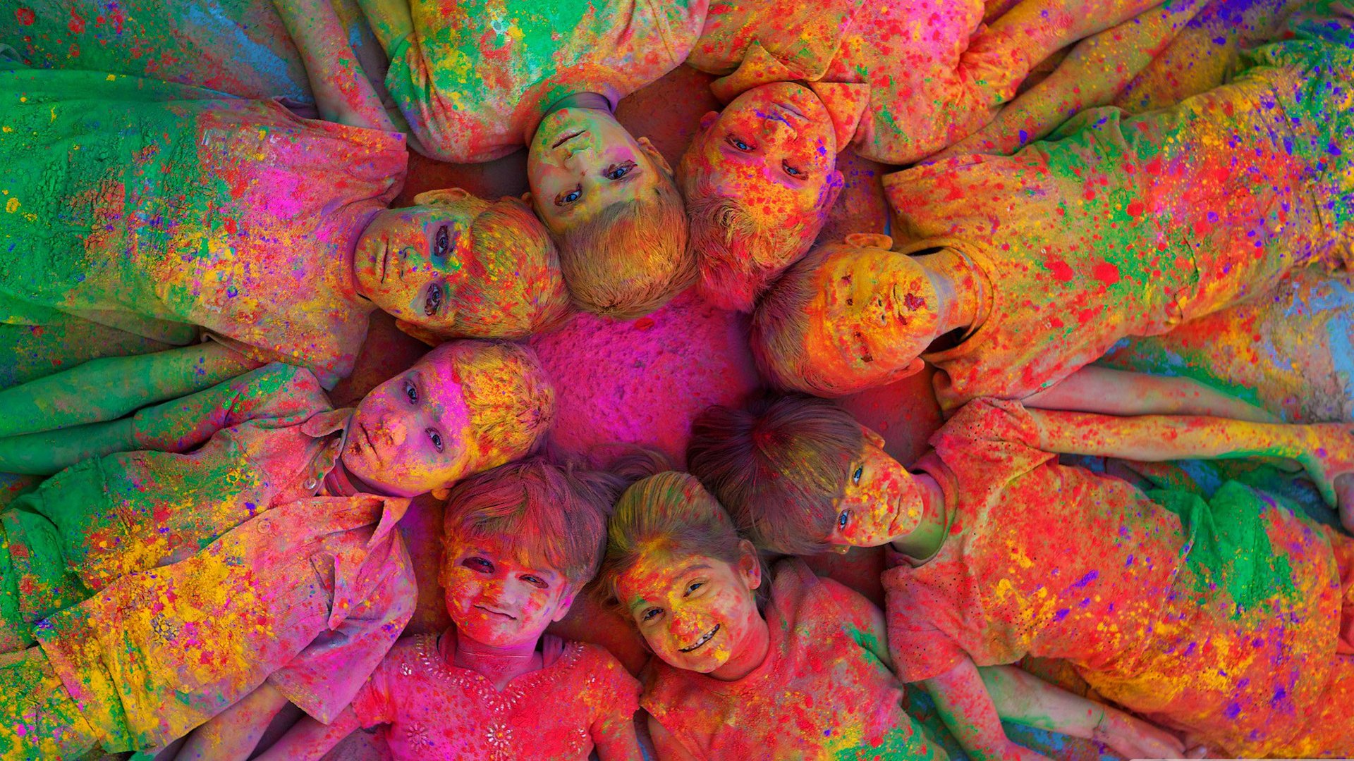 A vibrant, psychedelic image of children joyfully celebrating Holi, surrounded by a burst of colorful powders, creating a festive and lively atmosphere.